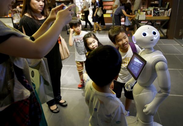 In this photo taken Sunday, July 12, 2015, children at a store in Tokyo try to talk with Pepper In this photo taken Sunday, July 12, 2015, children at a store in Tokyo try to talk with Pepper - Sputnik International