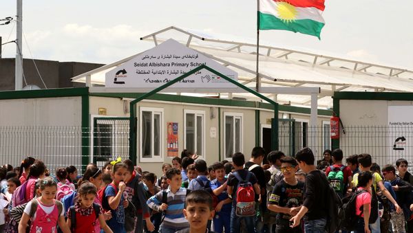Displaced Iraqi Christian children gather outside a primary school at the Ashti camp for people who fled the violence in the northern city of Mosul after jihadists of the Islamic State (IS) group took control of the area, on April 12, 2016 in Arbil, the capital of the autonomous Kurdish region of northern Iraq - Sputnik International