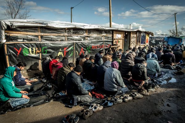 Men pray in the migrants and refugee camp in Calais, northern France. File photo Men pray in the migrants and refugee camp in Calais, northern France. File photo - Sputnik International