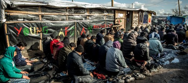 Men pray in the migrants and refugee camp in Calais, northern France. File photo Men pray in the migrants and refugee camp in Calais, northern France. File photo - Sputnik International