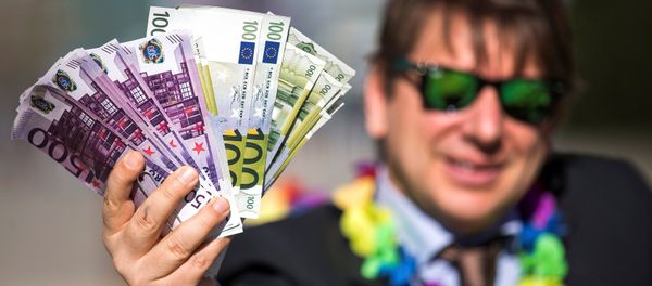 An activist shows fake banknotes during a demonstration outside the European Commission (EC) An activist shows fake banknotes during a demonstration outside the European Commission (EC) - Sputnik International