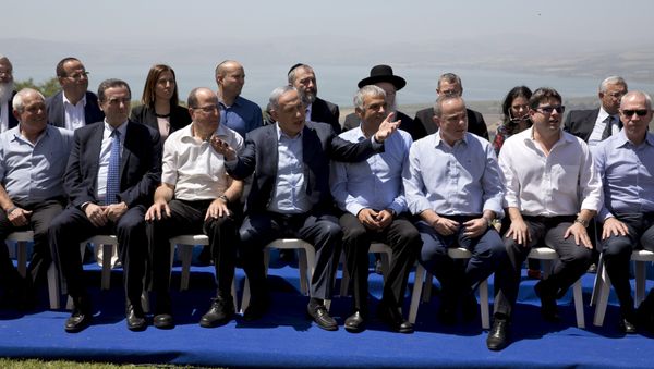 Israeli Prime Minister Benjamin Netanyahu (C front) poses with ministers prior to the weekly cabinet meeting in the Israeli occupied Golan Heights near the ceasefire line between Israel and Syria, April 17, 2016 - Sputnik International