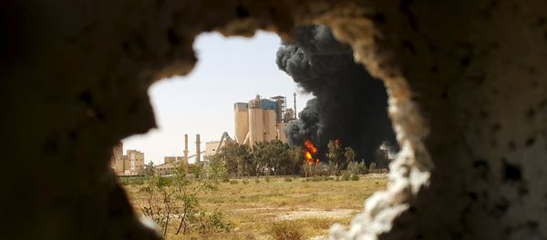 A fire is seen next to the Libyan cement factory A fire is seen next to the Libyan cement factory - Sputnik International