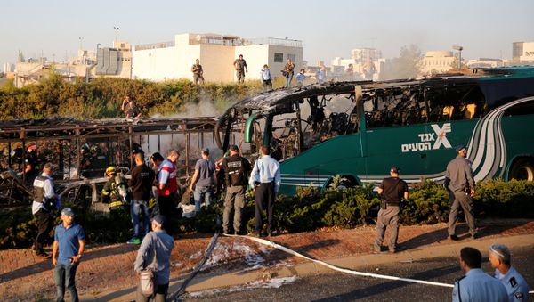 Emergency workers search the scene after a blast on a bus in Jerusalem Emergency workers search the scene after a blast on a bus in Jerusalem - Sputnik International
