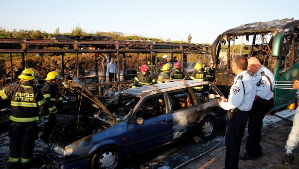 Emergency workers search the scene after a blast on a bus in Jerusalem Emergency workers search the scene after a blast on a bus in Jerusalem - Sputnik International