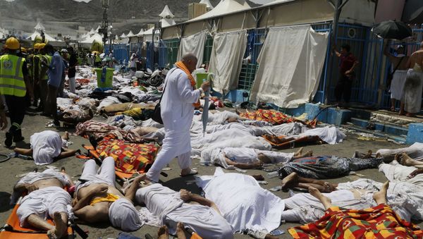 Muslim pilgrim walks through the site where dead bodies are gathered after a stampede during the annual hajj pilgrimage, in Mina, Saudi Arabia. (File) Muslim pilgrim walks through the site where dead bodies are gathered after a stampede during the annual hajj pilgrimage, in Mina, Saudi Arabia. (File) - Sputnik International