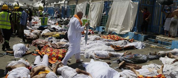 Muslim pilgrim walks through the site where dead bodies are gathered after a stampede during the annual hajj pilgrimage, in Mina, Saudi Arabia. (File) - Sputnik International