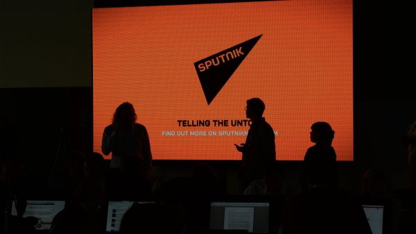 A screen with the logo of the Sputnik international news agency and radio - Sputnik International