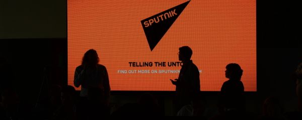 A screen with the logo of the Sputnik international news agency and radio A screen with the logo of the Sputnik international news agency and radio - Sputnik International
