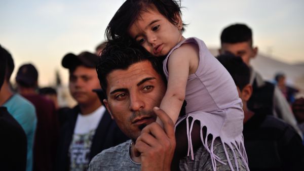 A man carries a child on his shoulders at the migrant and refugee makeshift camp near the village of Idomeni on the Greek-Macedonian border on April 16, 2016. A man carries a child on his shoulders at the migrant and refugee makeshift camp near the village of Idomeni on the Greek-Macedonian border on April 16, 2016. - Sputnik International