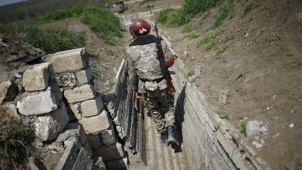 Ethnic Armenian soldiers walk in a trench at their position near Nagorno-Karabakh's town of Martuni, April 8, 2016 Ethnic Armenian soldiers walk in a trench at their position near Nagorno-Karabakh's town of Martuni, April 8, 2016 - Sputnik International