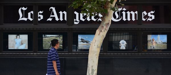A pedestrian walks past a display of photographs at the Los Angeles Times Building in downtown Los Angeles, California on July 10, 2013 A pedestrian walks past a display of photographs at the Los Angeles Times Building in downtown Los Angeles, California on July 10, 2013 - Sputnik International