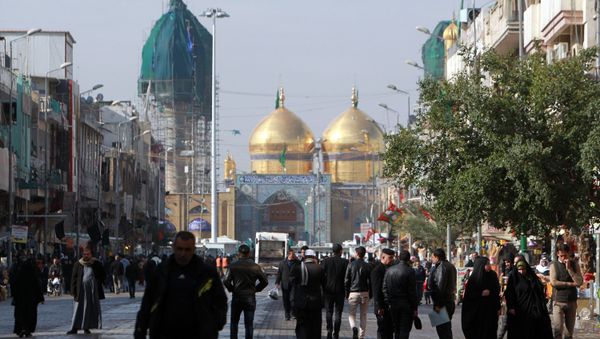 People gather outside the Shiite shrine of Imam Musa al-Kadhim, in Baghdad’s northern district of Kadhimiya on January 3, 2016 - Sputnik International