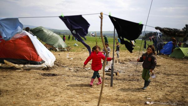 Children play during heavy winds at a makeshift camp for migrants and refugees at the Greek-Macedonian border near the village of Idomeni, Greece, April 11, 2016. Children play during heavy winds at a makeshift camp for migrants and refugees at the Greek-Macedonian border near the village of Idomeni, Greece, April 11, 2016. - Sputnik International