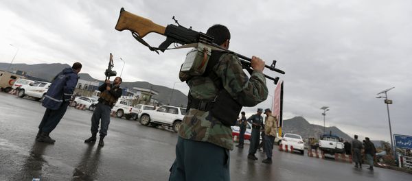 Afghan policemen stand guard at the site of a suicide car bomb attack on a government security building in Kabul, Afghanistan Afghan policemen stand guard at the site of a suicide car bomb attack on a government security building in Kabul, Afghanistan - Sputnik International
