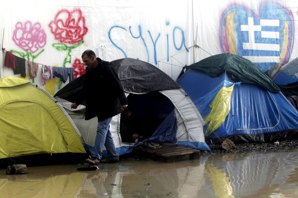 A refugee walks next to tents following heavy rainfall at a makeshift camp for migrants and refugees at the Greek-Macedonian border near the village of Idomeni, Greece, April 24, 2016. - Sputnik International