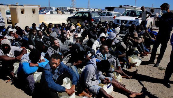 African illegal migrants wait to receive medial assistance after being rescued by coastal guards on a port in Tripoli, Libya. African illegal migrants wait to receive medial assistance after being rescued by coastal guards on a port in Tripoli, Libya. - Sputnik International