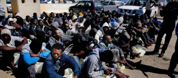 African illegal migrants wait to receive medial assistance after being rescued by coastal guards on a port in Tripoli, Libya. - Sputnik International
