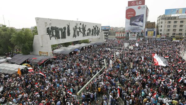 Followers of Iraq's Shi'ite cleric Moqtada al-Sadr gather and chant slogans during a protest demanding that parliament approves a long-delayed new cabinet and end political and sectarian wrangling that is hampering a vote on the matter, at Tahrir Square in Baghdad April 26, 2016 Followers of Iraq's Shi'ite cleric Moqtada al-Sadr gather and chant slogans during a protest demanding that parliament approves a long-delayed new cabinet and end political and sectarian wrangling that is hampering a vote on the matter, at Tahrir Square in Baghdad April 26, 2016 - Sputnik International