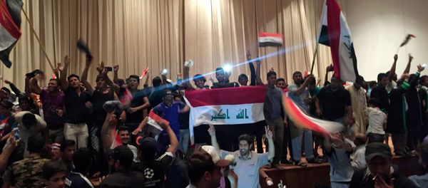 Followers of Iraq's Shi'ite cleric Moqtada al-Sadr are seen in the parliament building as they storm Baghdad's Green Zone after lawmakers failed to convene for a vote on overhauling the government, in Iraq April 30, 2016 Followers of Iraq's Shi'ite cleric Moqtada al-Sadr are seen in the parliament building as they storm Baghdad's Green Zone after lawmakers failed to convene for a vote on overhauling the government, in Iraq April 30, 2016 - Sputnik International