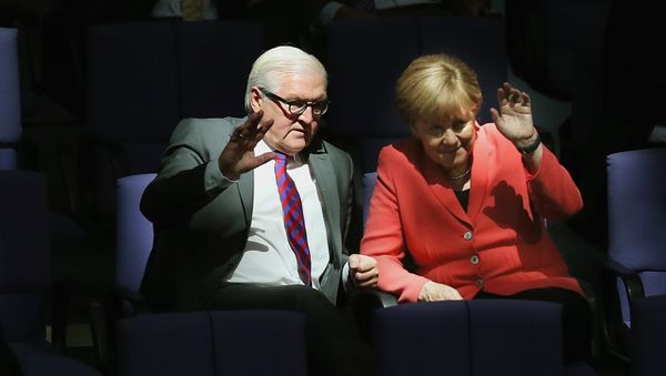 German Chancellor Angela Merkel, right, and Foreign Minister Frank-Walter Steinmeier wave as they attend a meeting of the German Federal Parliament, Bundestag, at the Reichstag building in Berlin, Germany, Thursday, Sept. 24, 2015 German Chancellor Angela Merkel, right, and Foreign Minister Frank-Walter Steinmeier wave as they attend a meeting of the German Federal Parliament, Bundestag, at the Reichstag building in Berlin, Germany, Thursday, Sept. 24, 2015 - Sputnik International