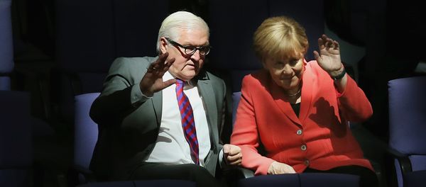 German Chancellor Angela Merkel, right, and Foreign Minister Frank-Walter Steinmeier wave as they attend a meeting of the German Federal Parliament, Bundestag, at the Reichstag building in Berlin, Germany, Thursday, Sept. 24, 2015 - Sputnik International