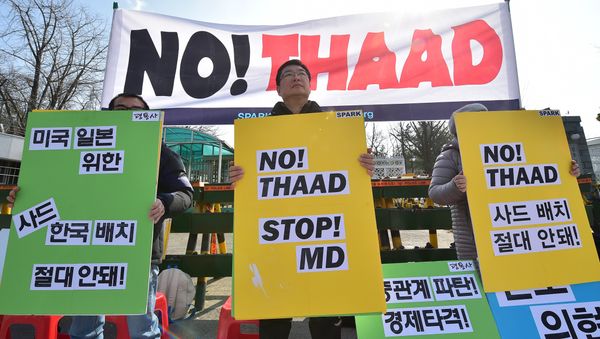 Anti-war activists hold placards during a rally against talks on deployment of the US-built Terminal High Altitude Area Defense, THAAD, outside South Korea's defence ministry in Seoul on March 4, 2016 Anti-war activists hold placards during a rally against talks on deployment of the US-built Terminal High Altitude Area Defense, THAAD, outside South Korea's defence ministry in Seoul on March 4, 2016 - Sputnik International