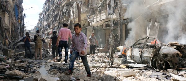 People walk amid the rubble of destroyed buildings following a reported air strike on the rebel-held neighbourhood of al-Kalasa in the northern Syrian city of Aleppo, on April 28, 2016 People walk amid the rubble of destroyed buildings following a reported air strike on the rebel-held neighbourhood of al-Kalasa in the northern Syrian city of Aleppo, on April 28, 2016 - Sputnik International