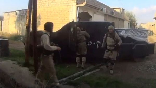 A man in an armoured vehicle, said to be a suicide bomber about to go out on a mission, talks to other Islamic State fighters in Iraq, in this still image taken from an amateur video supplied by Kurdish Peshmerga and received by Reuters on April 29, 2016 - Sputnik International