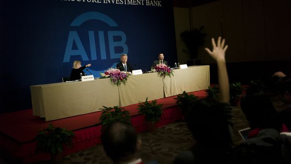 Jin Liqun (C), the first president of the Asian Infrastructure Investment Bank (AIIB), speaks to journalists during a press conference in Beijing on January 17, 2016 - Sputnik International