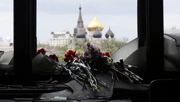 Flowers on a broken window in memory of the people killed by fire in the Trade Unions House on Odessa's Kulikovo Field Square. File photo Flowers on a broken window in memory of the people killed by fire in the Trade Unions House on Odessa's Kulikovo Field Square. File photo - Sputnik International