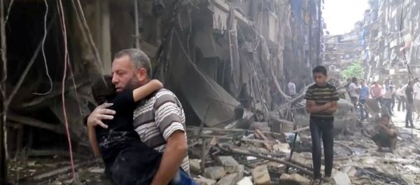 Man carries a child after airstrikes hit Aleppo, Syria, Thursday, April 28, 2016 - Sputnik International