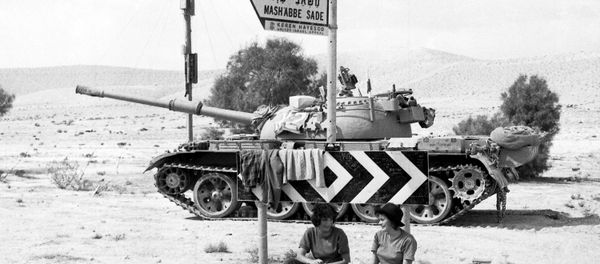 Two Israeli Army girls sit beneath a road sign, with a tank in the background, somewhere in the Sinai Desert, Oct. 8, 1973 Two Israeli Army girls sit beneath a road sign, with a tank in the background, somewhere in the Sinai Desert, Oct. 8, 1973 - Sputnik International