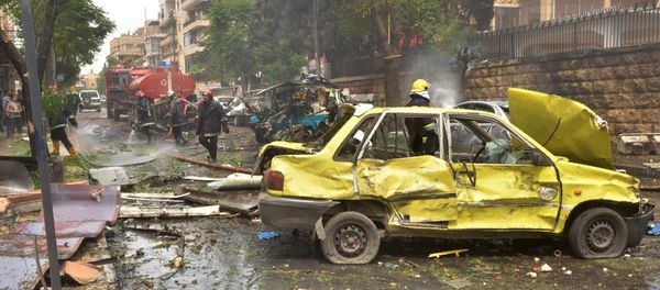 Syrian emergency personnel secure a street after rockets reportedly fired by rebels hit Al-Dabbeet hospital in the government-controlled neighbourhood of Muhafaza in the northern city of Aleppo on May 3, 2016 - Sputnik International
