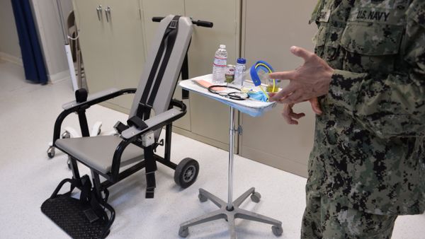 This photo reviewed by the US military and made during an escorted visit shows a US naval medic explaining the feeding chair procedures at the detention facility in Guantanamo Bay, Cuba, April 9, 2014. - Sputnik International