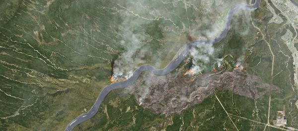 Smoke from wildfires near Fort McMurray, Alberta, Canada are shown in this satellite photo from NASA taken May 3, 2016. - Sputnik International