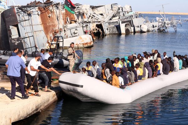 The Libyan coastguard pull a boat carrying illegal African migrants, rescued as they were trying to reach Europe, at a naval base near the capital Tripoli on September 29, 2015.  - Sputnik International