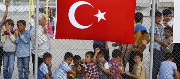 An elderly refugee man stands with children as they wait for the arrival of German Chancellor Angela Merkel, Turkish Prime Minister Ahmet Davutoglu, EU Council President Donald Tusk and European Commission Vice-President Frans Timmermans (all not pictured) at Nizip refugee camp near Gaziantep, Turkey, April 23, 2016.s An elderly refugee man stands with children as they wait for the arrival of German Chancellor Angela Merkel, Turkish Prime Minister Ahmet Davutoglu, EU Council President Donald Tusk and European Commission Vice-President Frans Timmermans (all not pictured) at Nizip refugee camp near Gaziantep, Turkey, April 23, 2016.s - Sputnik International