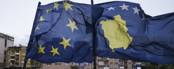 Kosovar Albanians walk under the EU and Kosovo flags in the main square of Pristina on May 4, 2016. - Sputnik International