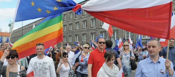 Opponents of Poland's government carry a Polish and EU flags tied together as they march downtown streets to protest the country's direction under a conservative government that is accused of eroding the rule of law, in Warsaw, Poland, Saturday, May 7, 2016. Opponents of Poland's government carry a Polish and EU flags tied together as they march downtown streets to protest the country's direction under a conservative government that is accused of eroding the rule of law, in Warsaw, Poland, Saturday, May 7, 2016. - Sputnik International