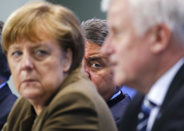 German Economy Minister Siegmar Gabriel (C) peers between Chancellor Angela Merkel and Bavarian state premier and leader of the Christian Social Union (CSU) Horst Seehofer during a news conference at the Chancellery in Berlin, Germany, April 14, 2016. German Economy Minister Siegmar Gabriel (C) peers between Chancellor Angela Merkel and Bavarian state premier and leader of the Christian Social Union (CSU) Horst Seehofer during a news conference at the Chancellery in Berlin, Germany, April 14, 2016. - Sputnik International