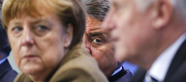 German Economy Minister Siegmar Gabriel (C) peers between Chancellor Angela Merkel and Bavarian state premier and leader of the Christian Social Union (CSU) Horst Seehofer during a news conference at the Chancellery in Berlin, Germany, April 14, 2016. German Economy Minister Siegmar Gabriel (C) peers between Chancellor Angela Merkel and Bavarian state premier and leader of the Christian Social Union (CSU) Horst Seehofer during a news conference at the Chancellery in Berlin, Germany, April 14, 2016. - Sputnik International