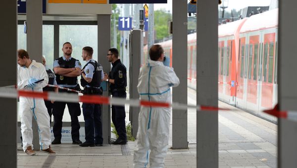 Forensic experts of the police stand next to a commuter train standig on a platform of the train station of Grafing near Munich, southern Germany, where a man killed one person and wounded three others in a knife attack on May 10, 2016 Forensic experts of the police stand next to a commuter train standig on a platform of the train station of Grafing near Munich, southern Germany, where a man killed one person and wounded three others in a knife attack on May 10, 2016 - Sputnik International