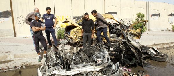 Iraqi men inspect the site of car bomb attack in Baghdad, Iraq (File) Iraqi men inspect the site of car bomb attack in Baghdad, Iraq (File) - Sputnik International