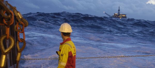 A worker on board the Bourbon Orca tug boat looks at the sea as they prepare to unload drilling equipment for an oil in the Norwegian sea (File) - Sputnik International