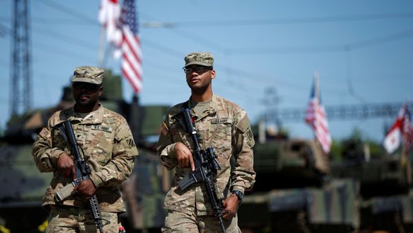 U.S. servicemen walk past U.S. M1A2 Abrams tanks as they arrive for the joint U.S.-Georgian exercise Noble Partner 2016 in Vaziani, Georgia, May 5, 2016 - Sputnik International