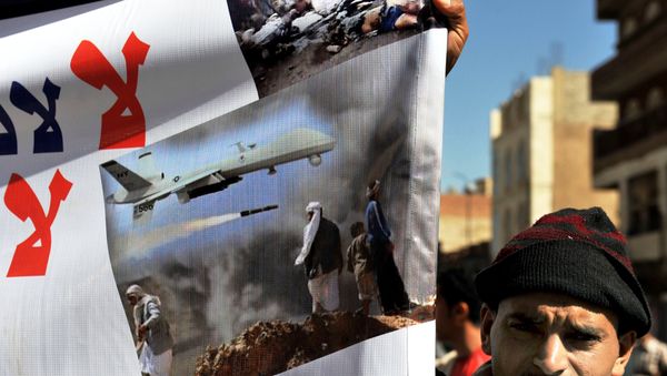 A Yemeni hold up a banner during a protest against US drone attacks on Yemen close to the home of Yemeni President Abdrabuh Mansur Hadi, in the capital Sanaa, on January 28, 2013. - Sputnik International