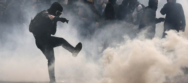 A protester kicks back a teargas grenade during a demonstration against French labour law reform in Paris, France, May 12, 2016. A protester kicks back a teargas grenade during a demonstration against French labour law reform in Paris, France, May 12, 2016. - Sputnik International