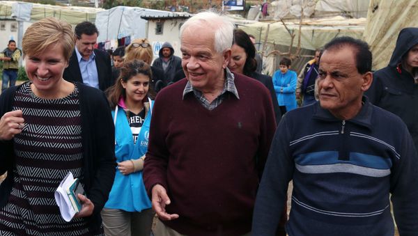 Canadian Minister of Immigration John McCallum, center, walks during his visit to a Syrian refugee camp. Canadian Minister of Immigration John McCallum, center, walks during his visit to a Syrian refugee camp. - Sputnik International