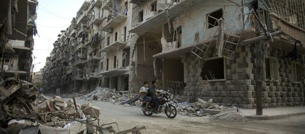 Syrian men ride a motorbike past damaged buildings in the rebel-held Bustan al-Qasr district in eastern Aleppo Syrian men ride a motorbike past damaged buildings in the rebel-held Bustan al-Qasr district in eastern Aleppo - Sputnik International